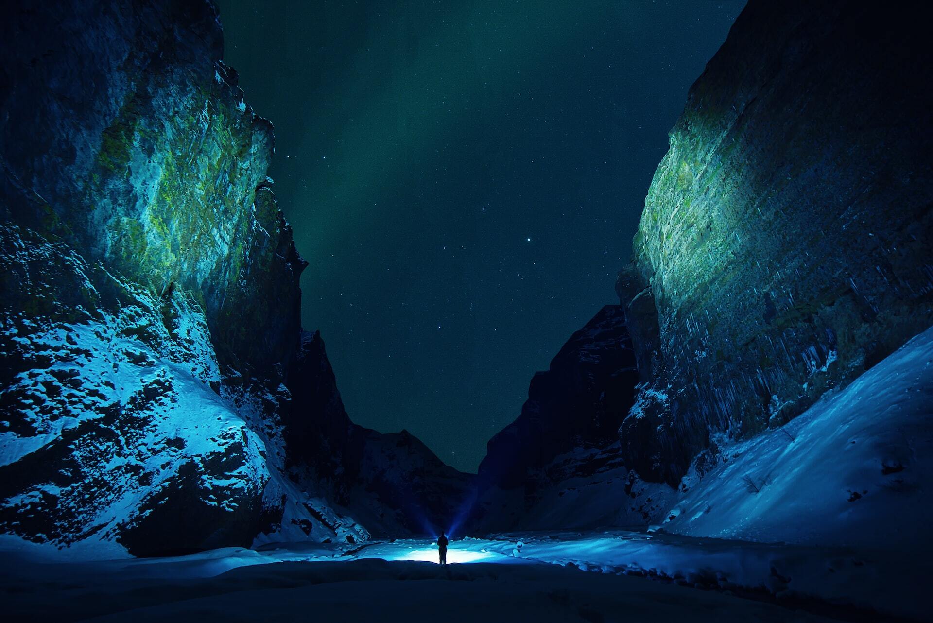 man in middle of northern lights